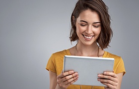 Smiling woman looking at tablet computer