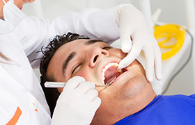 Man receiving oral cancer screening