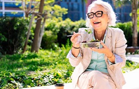 Lady enjoys salad outside