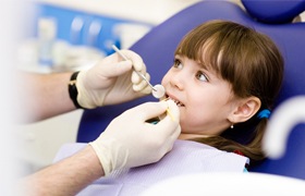 Young girl receiving dental treatment