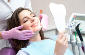 young woman smiling in dental chair