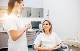 a patient talking to dentist about tooth extractions in Aurora