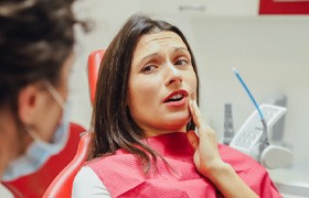 Woman with toothache at dentist