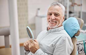 happy senior man sitting in the dental chair