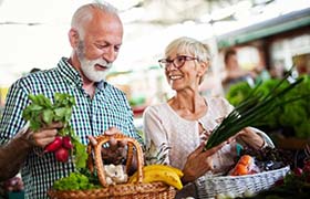 senior man and woman buying fruits and vegetables