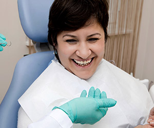 Laughing woman in dental chair