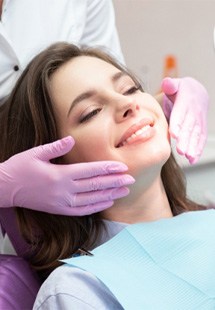 woman smiling while visiting cosmetic dentist 