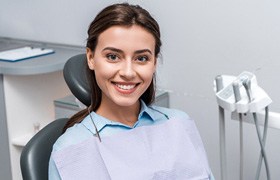 A smiling young woman sitting in a dentist’s chair