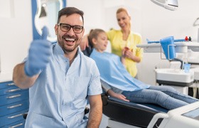 Implant dentist in Aurora smiling and giving thumbs up