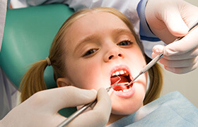 Little girl receiving dental exam