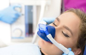 Closeup of woman relaxing in a dental chair with a nitrous oxide mask