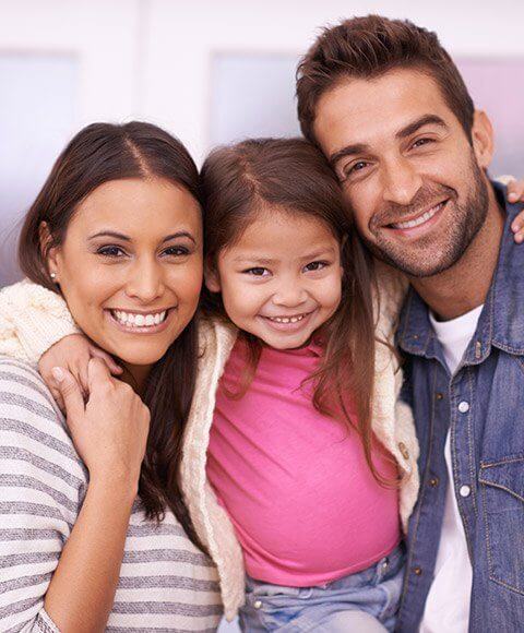 Grinning family of three