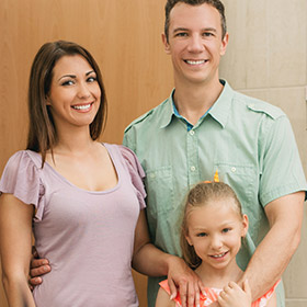 Smiling family of three