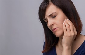 Woman rubbing jaw