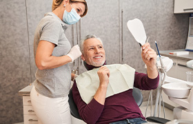 man talking to dentist about cost of veneers in Aurora 