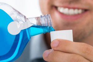 Aurora dentist pours antimicrobial mouthwash before appointment in COVID-19