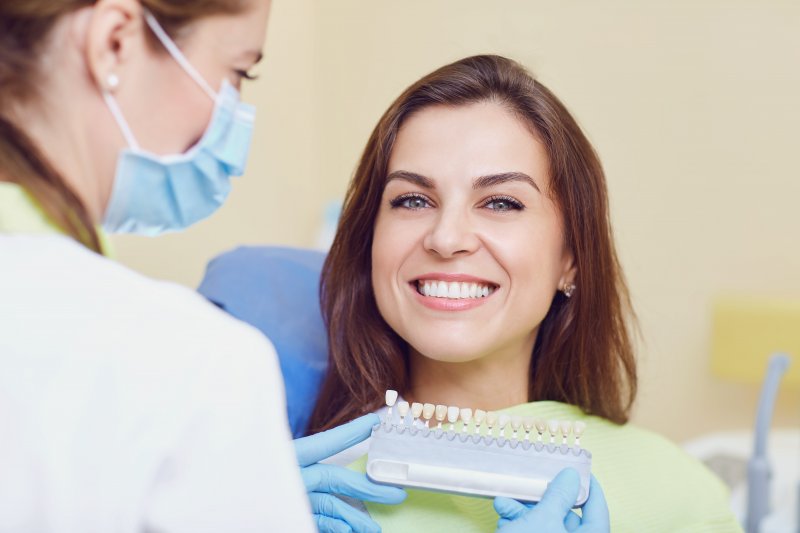 patient smiling while getting dental crown in Aurora