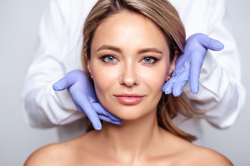 A woman smiling after her cosmetic dentistry appointment