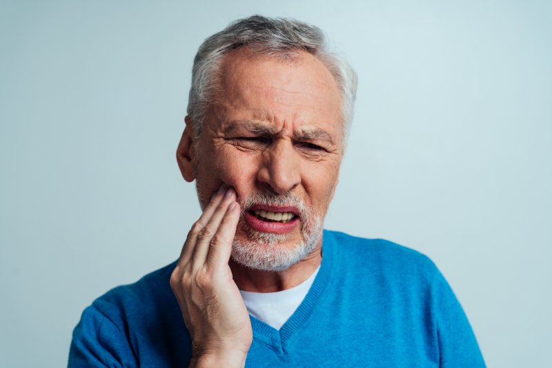 An older man suffering from ill-fitting dentures